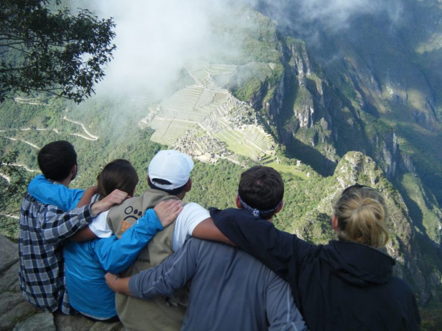 Inca Jungle Trail - Tourists embrace as they gaze at Machu Piucchu from afar.