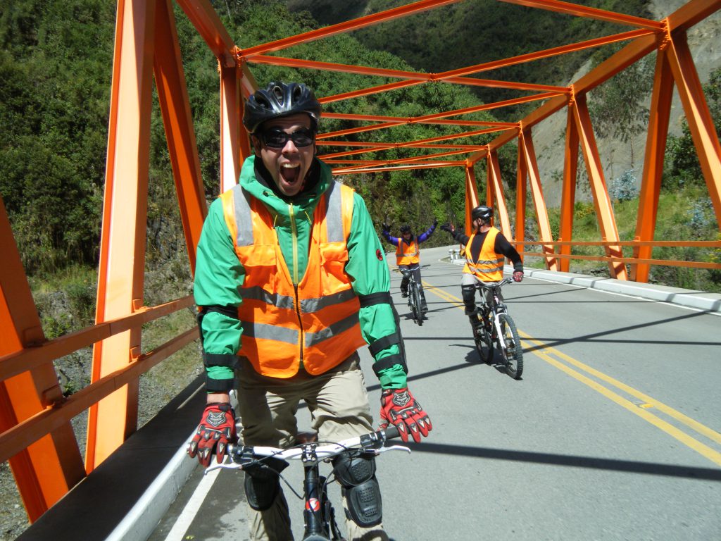 Inca Jungle Trail - Excited cyclist crosses a bridge.