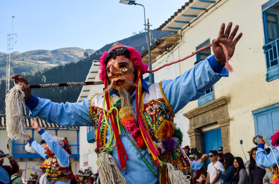 A cheeky performer uses a whip to keep the crowds in line