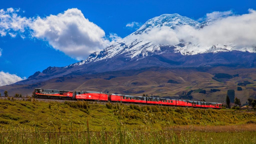 Ecuador Cruise Train, Tren Crucero, passes a snow-capped volcano