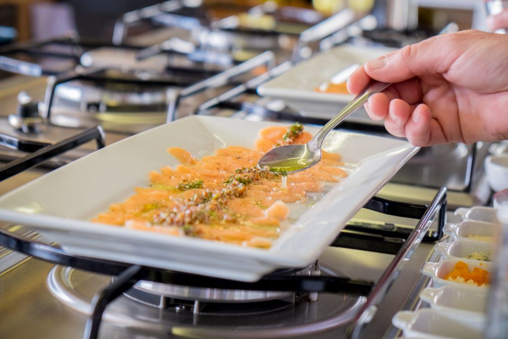 Cooking class in Cusco - Curing trout slices with lime juice.